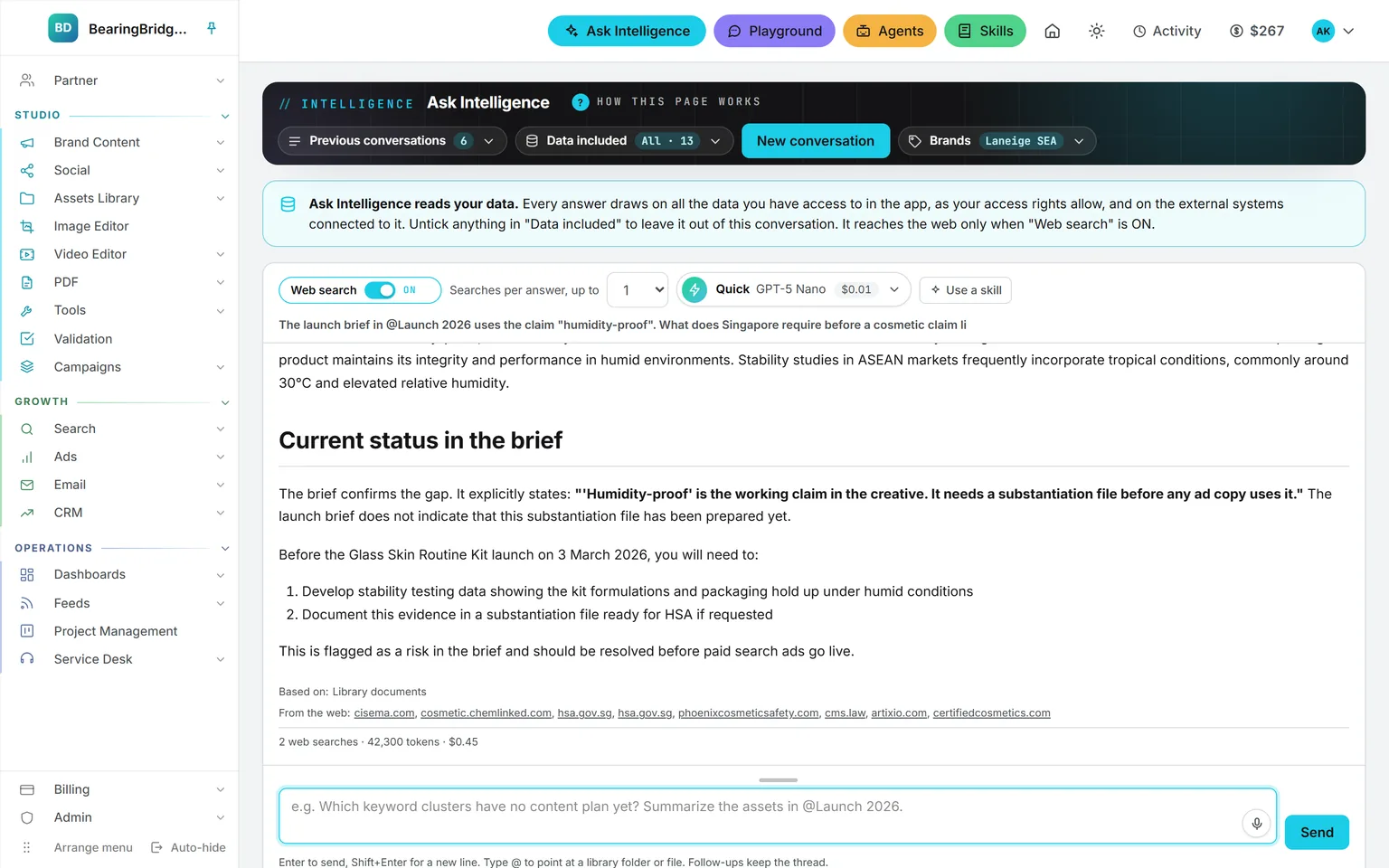 An Ask answer with web search on: the launch brief read from the library, seven government and industry sites listed separately, and two web searches counted alongside the tokens and price